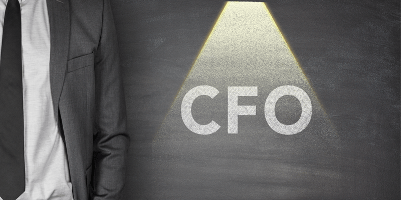 A spotlight on the word CFO with a person in a suit next to it, in a visualisation of CFOs being scrutinised.