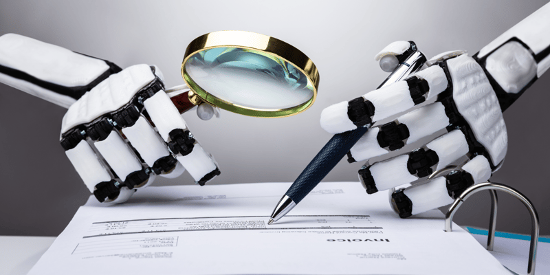 A pair of robot hands with a magnifying glass and a pen hovering over an invoice.