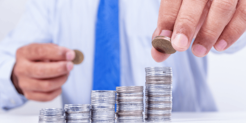 Picture of a man moving coins from one stack to another stack