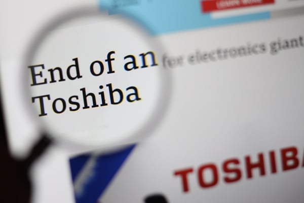 Magnifying glass highlighting the words “The end of an era for Toshiba.